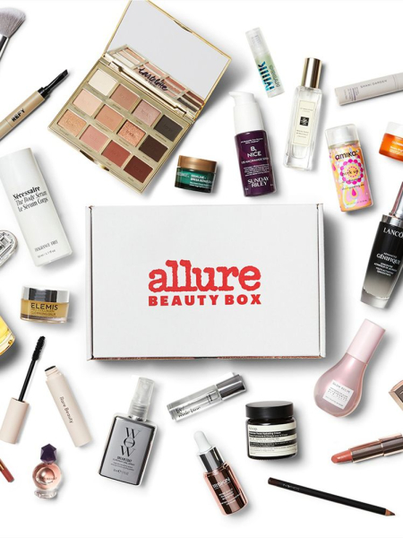 Allure Beauty Box flat lay of beauty products and white box on white background