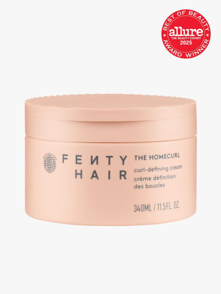 Fenty Hair The Homecurl Curl-Defining Cream in branded coral jar with snap lid closure on light gray background with red Allure Best of Beauty seal in the top right corner